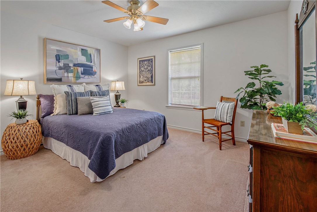 1110 County Road 439 Dime Box, TX 77853 - Photo 30 of 50 a spacious bedroom with a bed and a potted plant