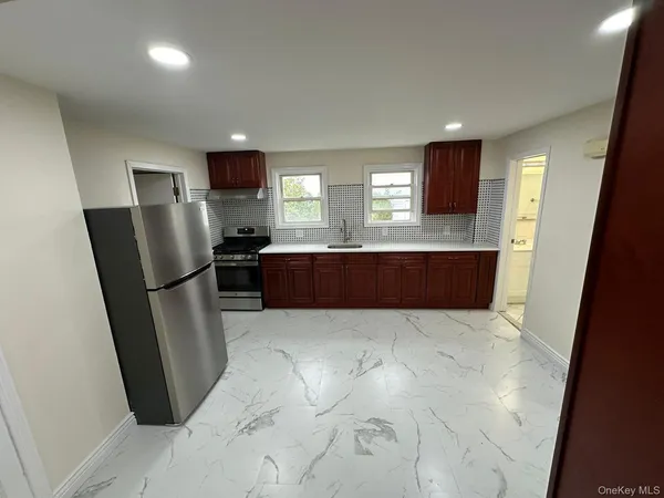 a view of kitchen with refrigerator microwave and wooden floor