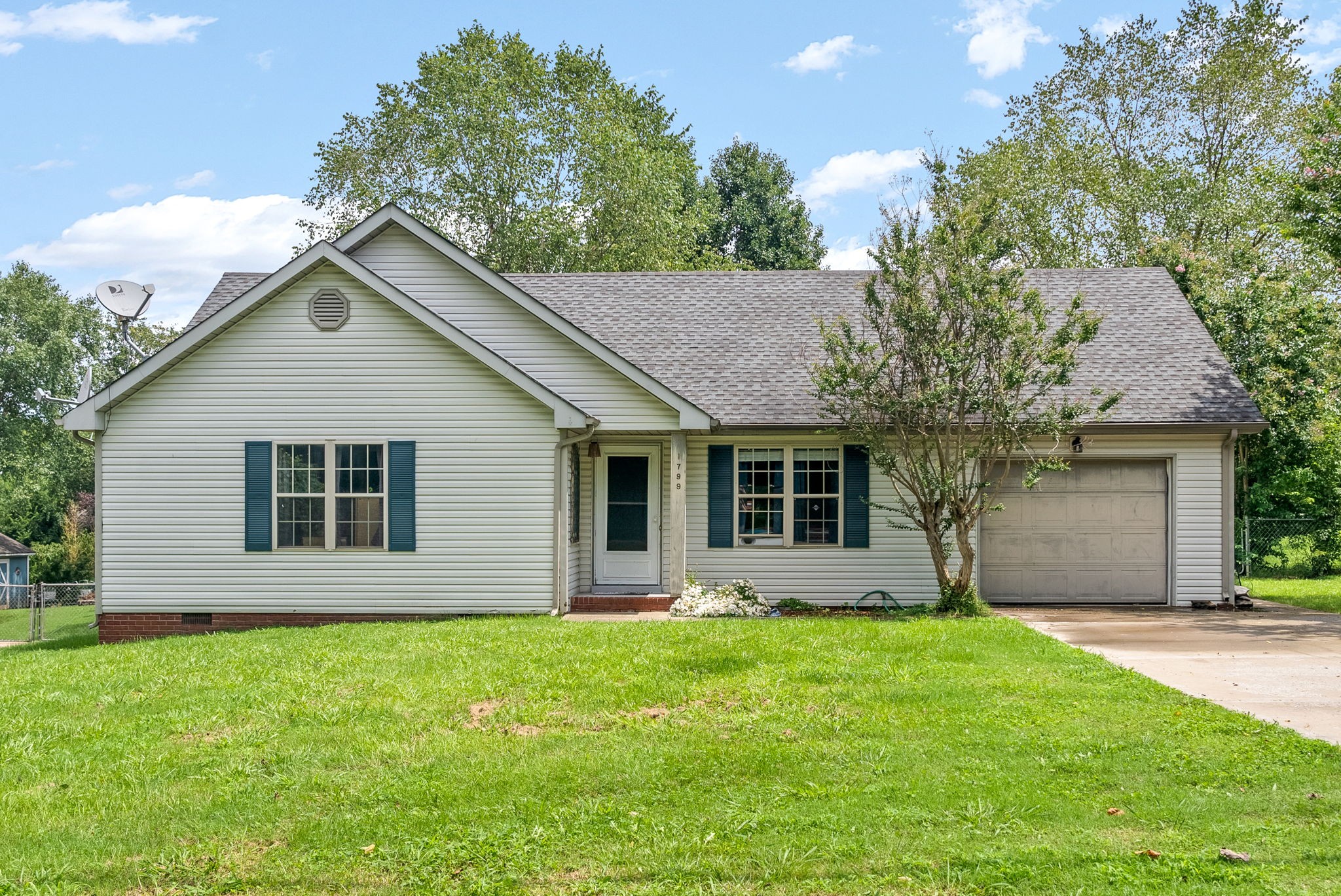 a front view of house with yard and green space