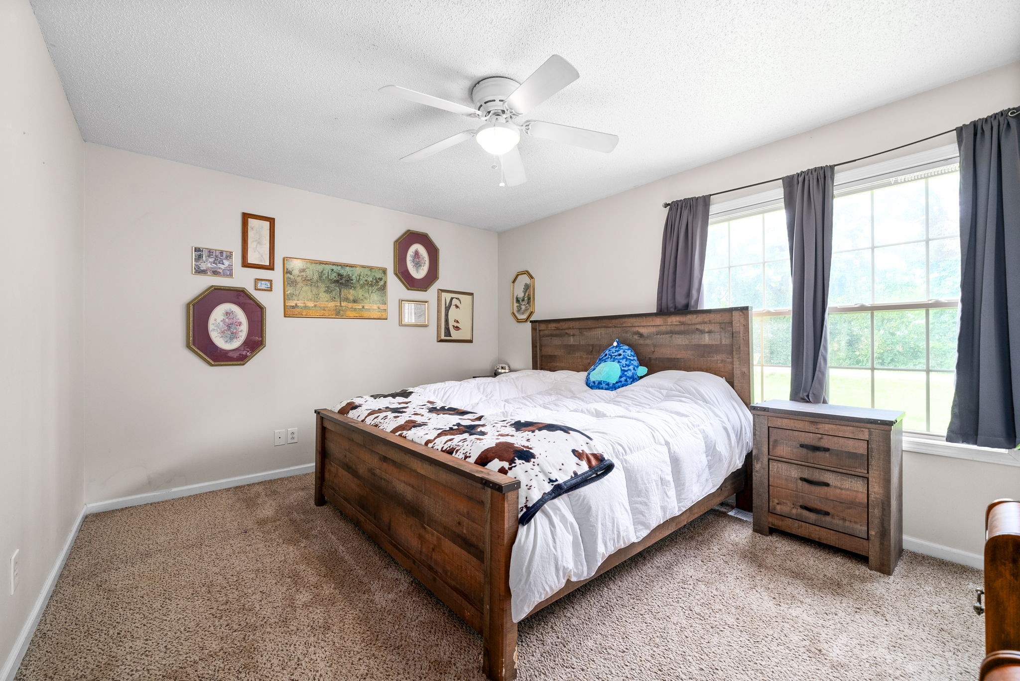 1799 Needmore Road Clarksville, TN 37042 - Photo 15 of 27 a bed sitting in a bedroom next to a window