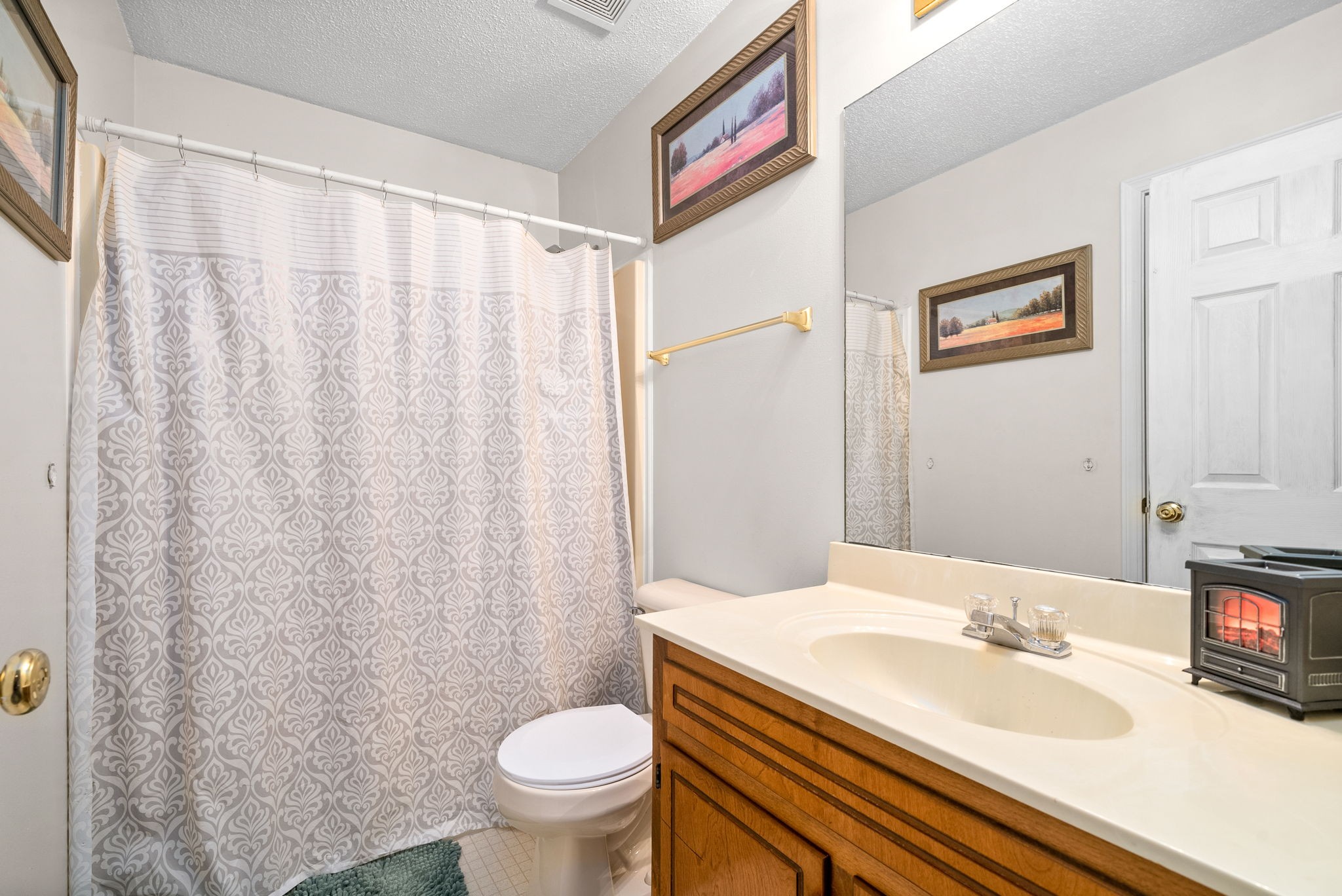 1799 Needmore Road Clarksville, TN 37042 - Photo 20 of 27 a bathroom with a sink a toilet and a mirror
