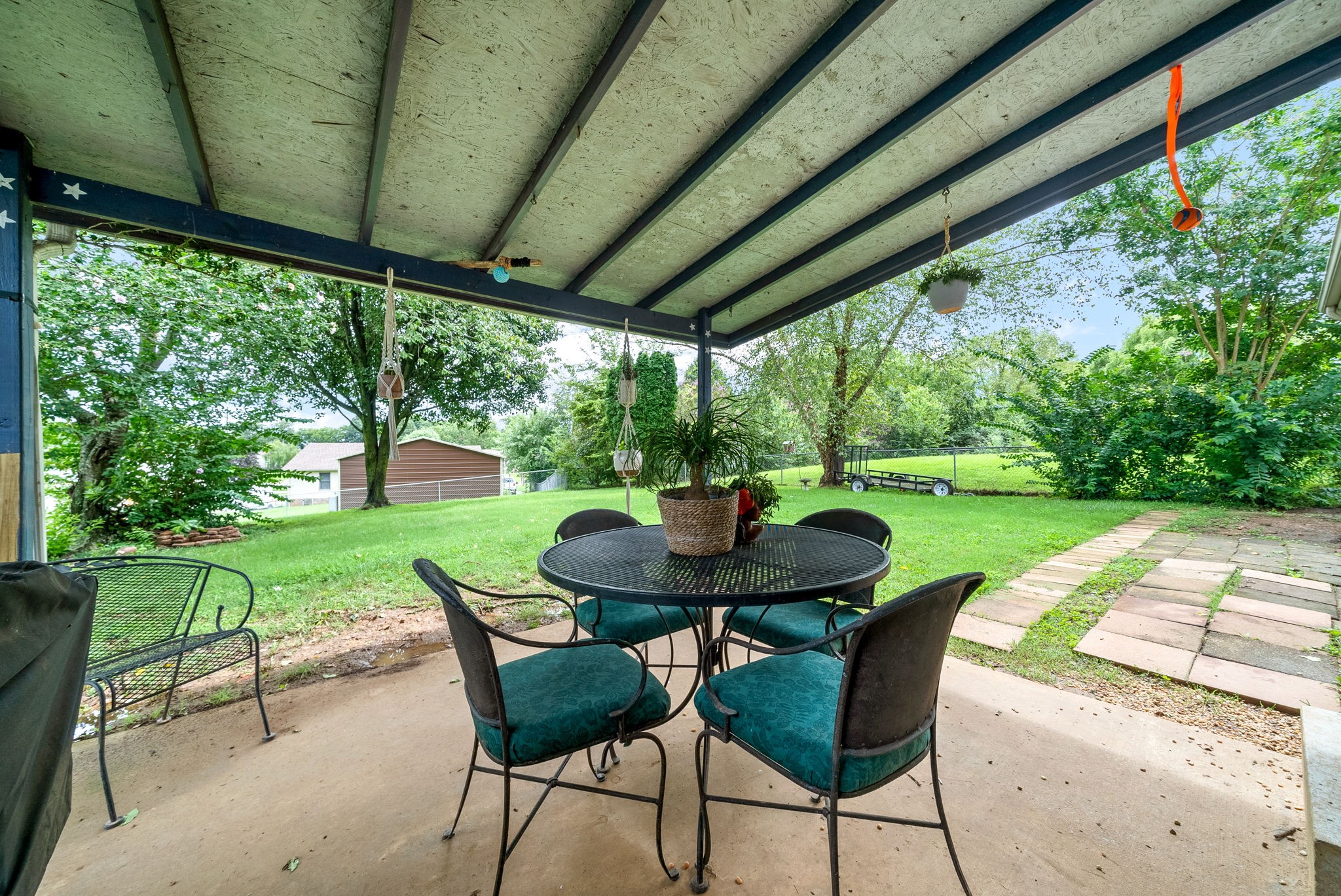 1799 Needmore Road Clarksville, TN 37042 - Photo 22 of 27 a view of a table and chairs in backyard of a house