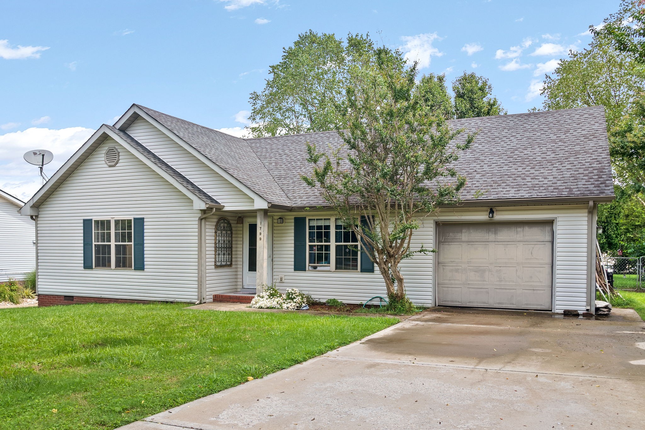 1799 Needmore Road Clarksville, TN 37042 - Photo 4 of 27 a front view of a house with a garden and yard