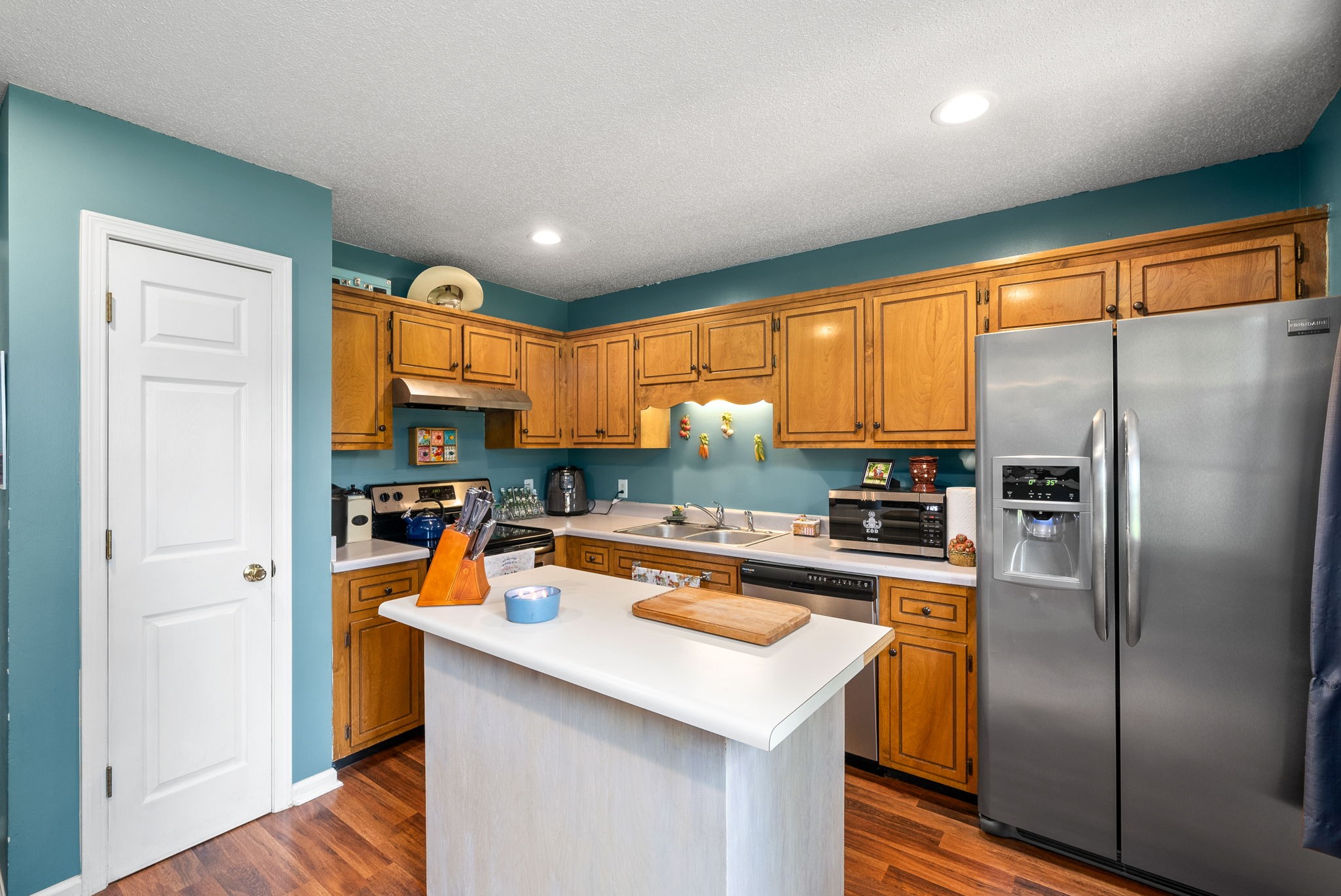 1799 Needmore Road Clarksville, TN 37042 - Photo 9 of 27 a kitchen with stainless steel appliances granite countertop a refrigerator a sink dishwasher a stove and a refrigerator with wooden floor