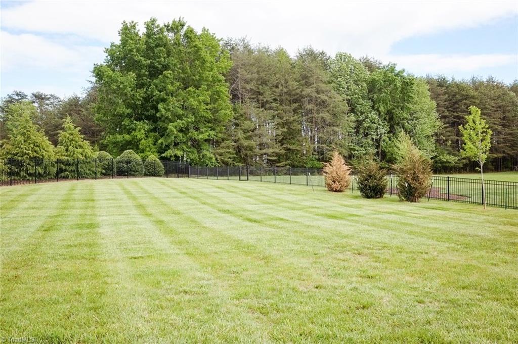 7790 Sutter Road Greensboro, NC 27455 - Photo 29 of 30 Vast yard that backs up to Northern High School. Gate door at back of property for walking to school.
