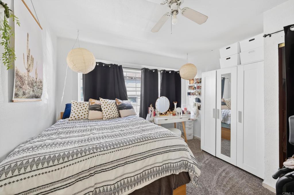 1530 East Appleton Street Long Beach, CA 90802 - Photo 9 of 61 a bedroom with a large bed and a chandelier