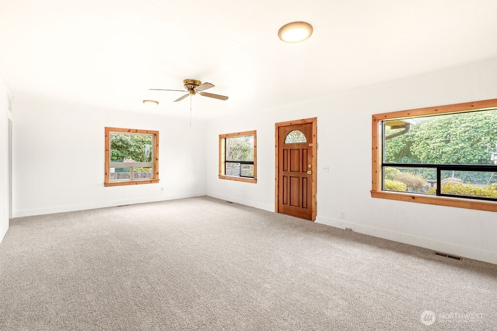 7302 Blaine Road Aberdeen, WA 98520 - Photo 5 of 38 an empty room with windows and ceiling fan view