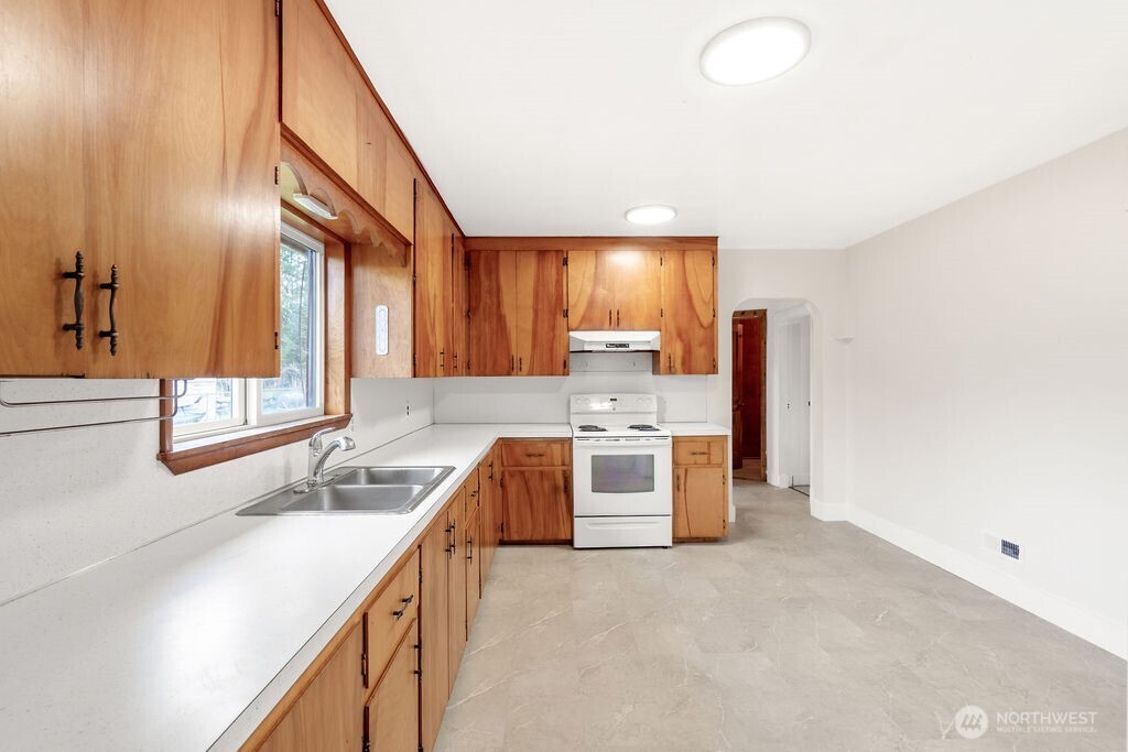 7302 Blaine Road Aberdeen, WA 98520 - Photo 6 of 38 a kitchen with stainless steel appliances a sink and a stove