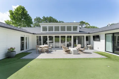 a view of a house with sitting area and garden