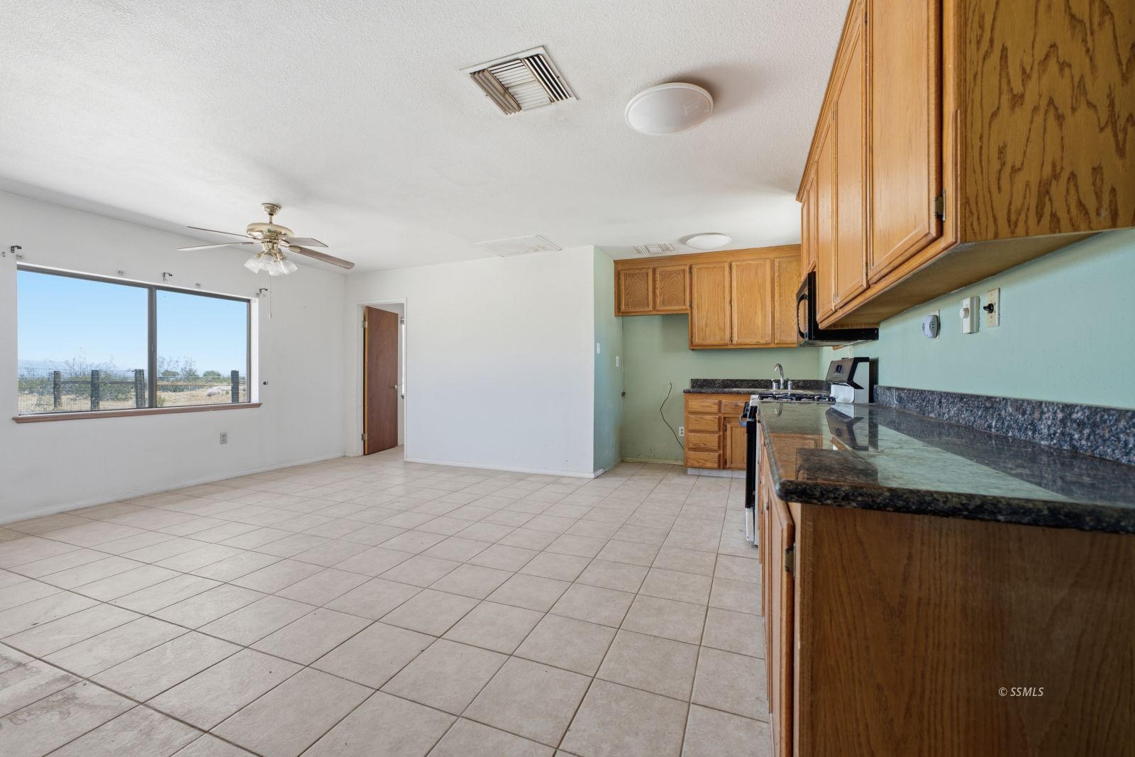 3443 3rd Street Inyokern, CA 93527 - Photo 5 of 24 a kitchen with granite countertop a sink and a stove