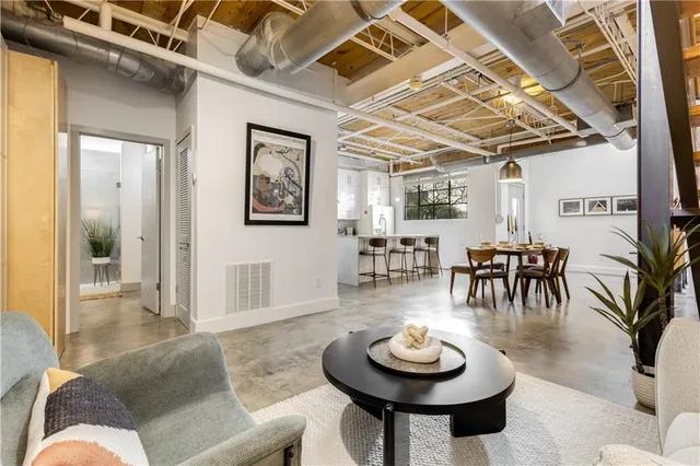a view of kitchen with stainless steel appliances granite countertop a stove and a refrigerator