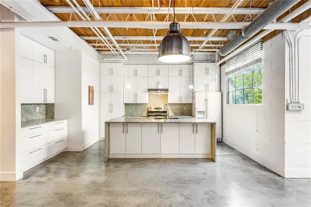 a kitchen with a sink cabinets and window