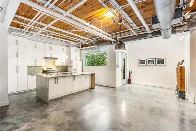 a large white kitchen with a stove a sink and dishwasher