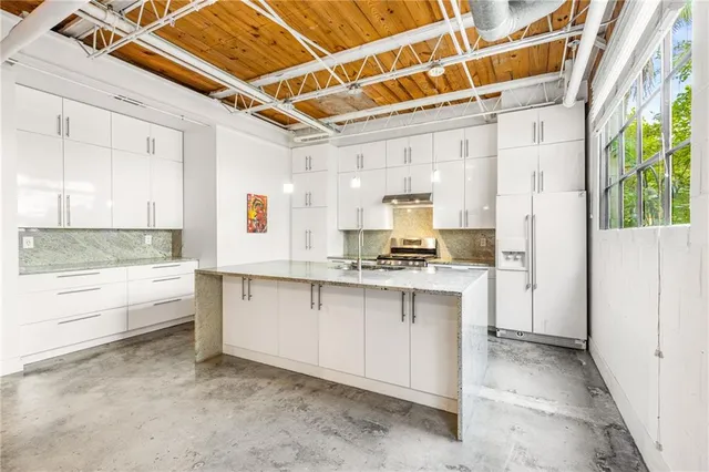 a kitchen with stainless steel appliances granite countertop a sink stove and cabinets