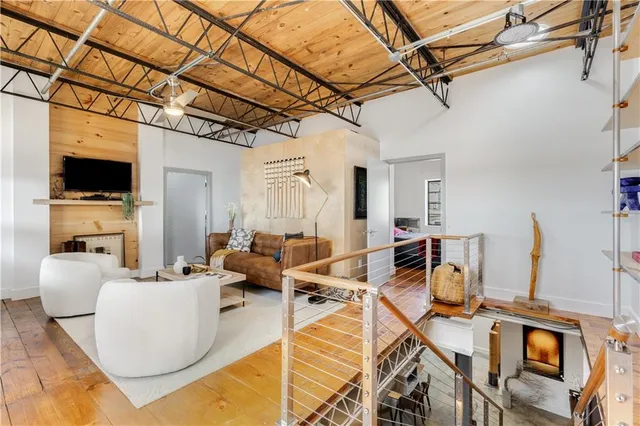 a view of a room with wooden floor and door