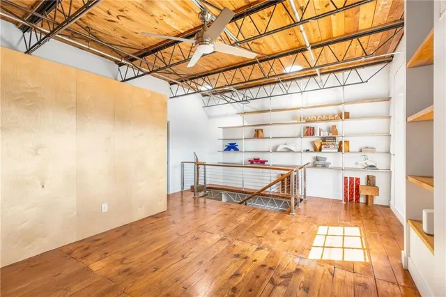 a hallway with a wooden floor and a dining table