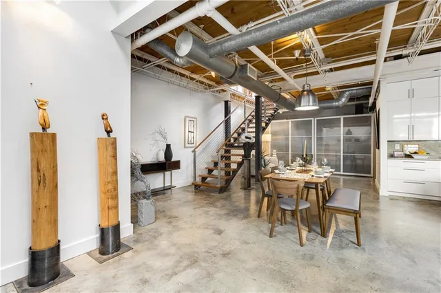 a view of a livingroom with furniture and floor to ceiling window