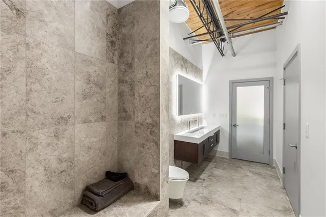 an aerial view of a house with a garden and lake view