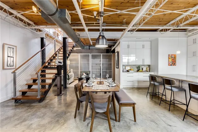 a dining room with wooden floor a table and chairs
