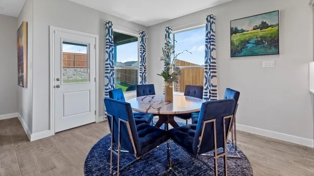 a living room with furniture kitchen view and a chandelier