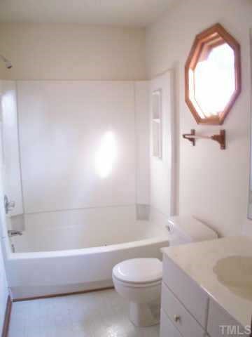 809 West C Street Butner, NC 27509 - Photo 11 of 12 a bathroom with a toilet a sink and bathtub