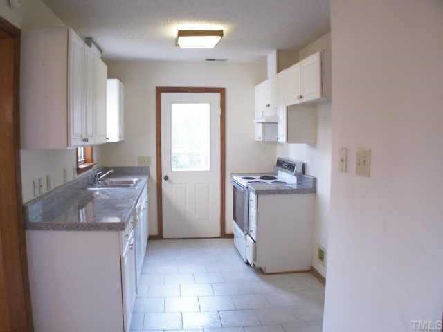 809 West C Street Butner, NC 27509 - Photo 5 of 12 a kitchen with a sink stove and cabinets