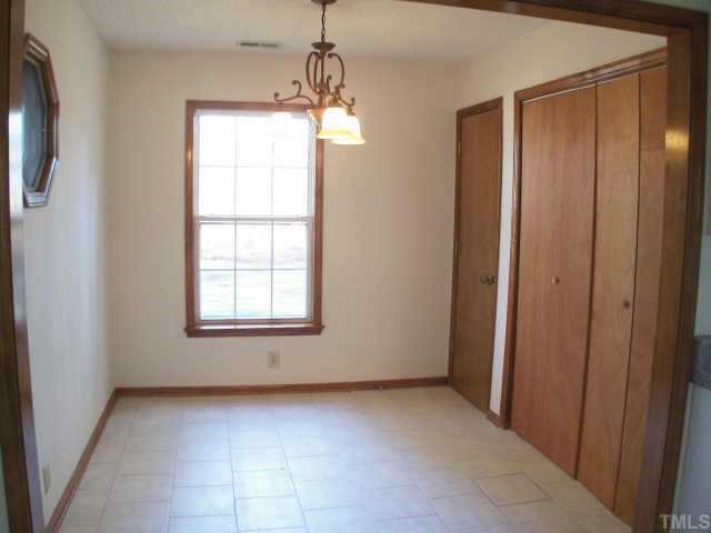 809 West C Street Butner, NC 27509 - Photo 6 of 12 a view of an empty room with a window