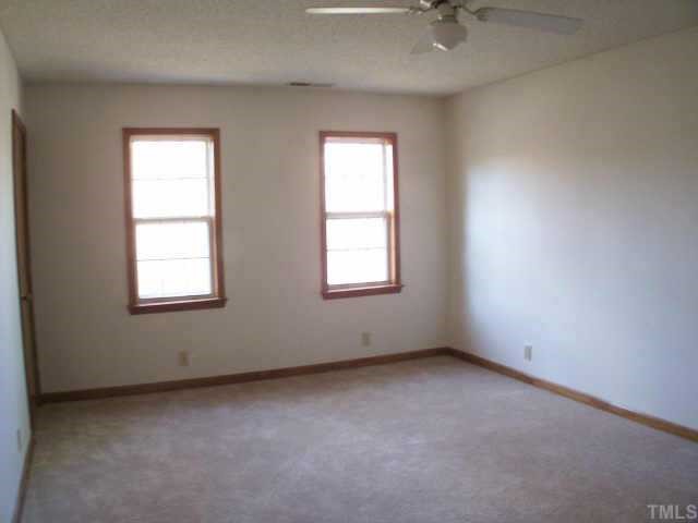 809 West C Street Butner, NC 27509 - Photo 8 of 12 an empty room with a window