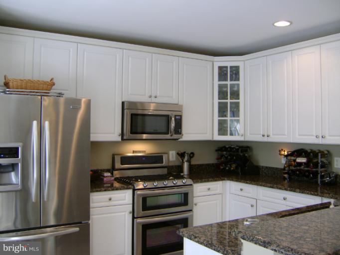 1967 Logan Manor Drive Reston, VA 20190 - Photo 2 of 30 a kitchen with stainless steel appliances granite countertop a refrigerator stove top oven and sink