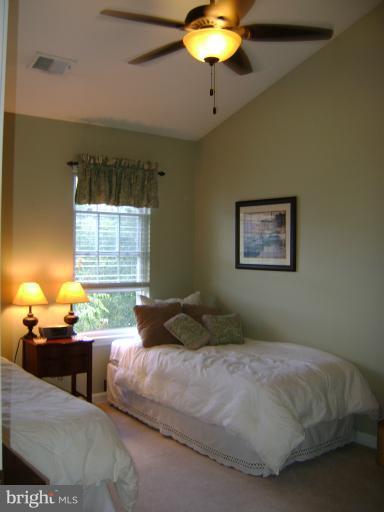 1967 Logan Manor Drive Reston, VA 20190 - Photo 11 of 30 a bedroom with a bed and a chandelier