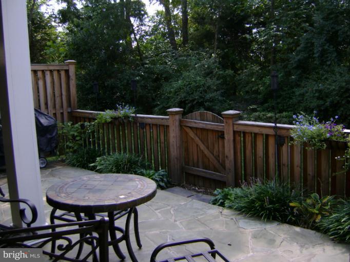 1967 Logan Manor Drive Reston, VA 20190 - Photo 13 of 30 a view of a backyard with plants and wooden fence