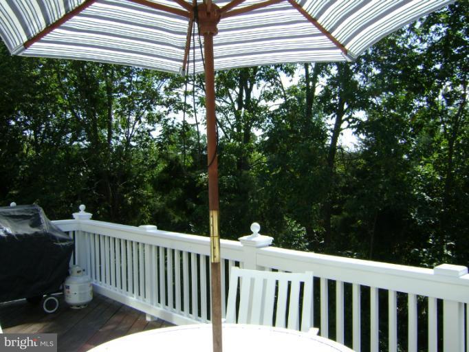 1967 Logan Manor Drive Reston, VA 20190 - Photo 15 of 30 a view of a white house with a small yard and deck