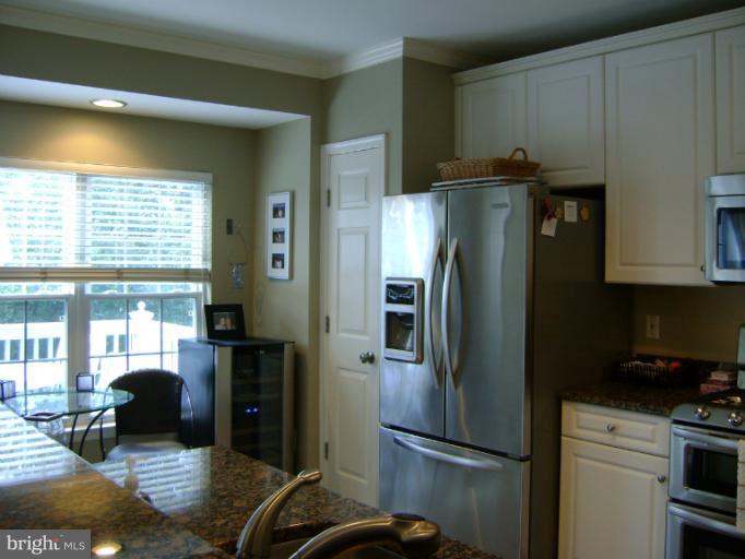 1967 Logan Manor Drive Reston, VA 20190 - Photo 7 of 30 a kitchen with metallic refrigerator and cabinets