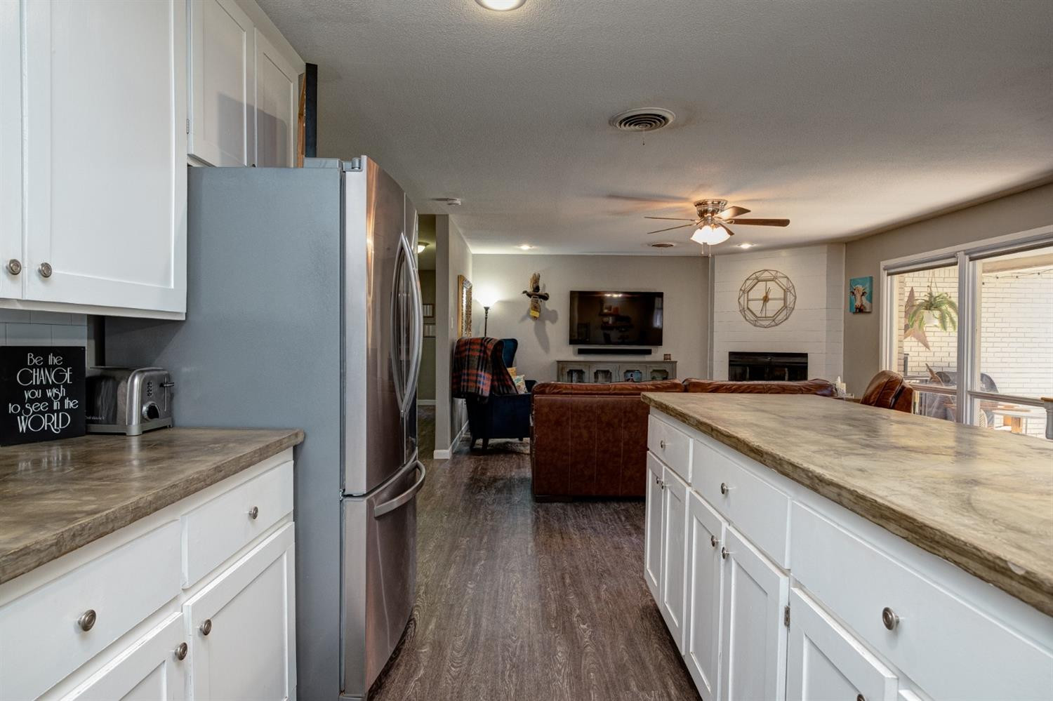 5209 16th Street Lubbock, TX 79416 - Photo 11 of 23 a kitchen with granite countertop a refrigerator stove top oven and sink