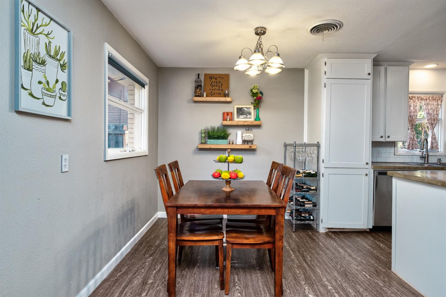 5209 16th Street Lubbock, TX 79416 - Photo 13 of 23 a dining room filled chandelier and wooden floor