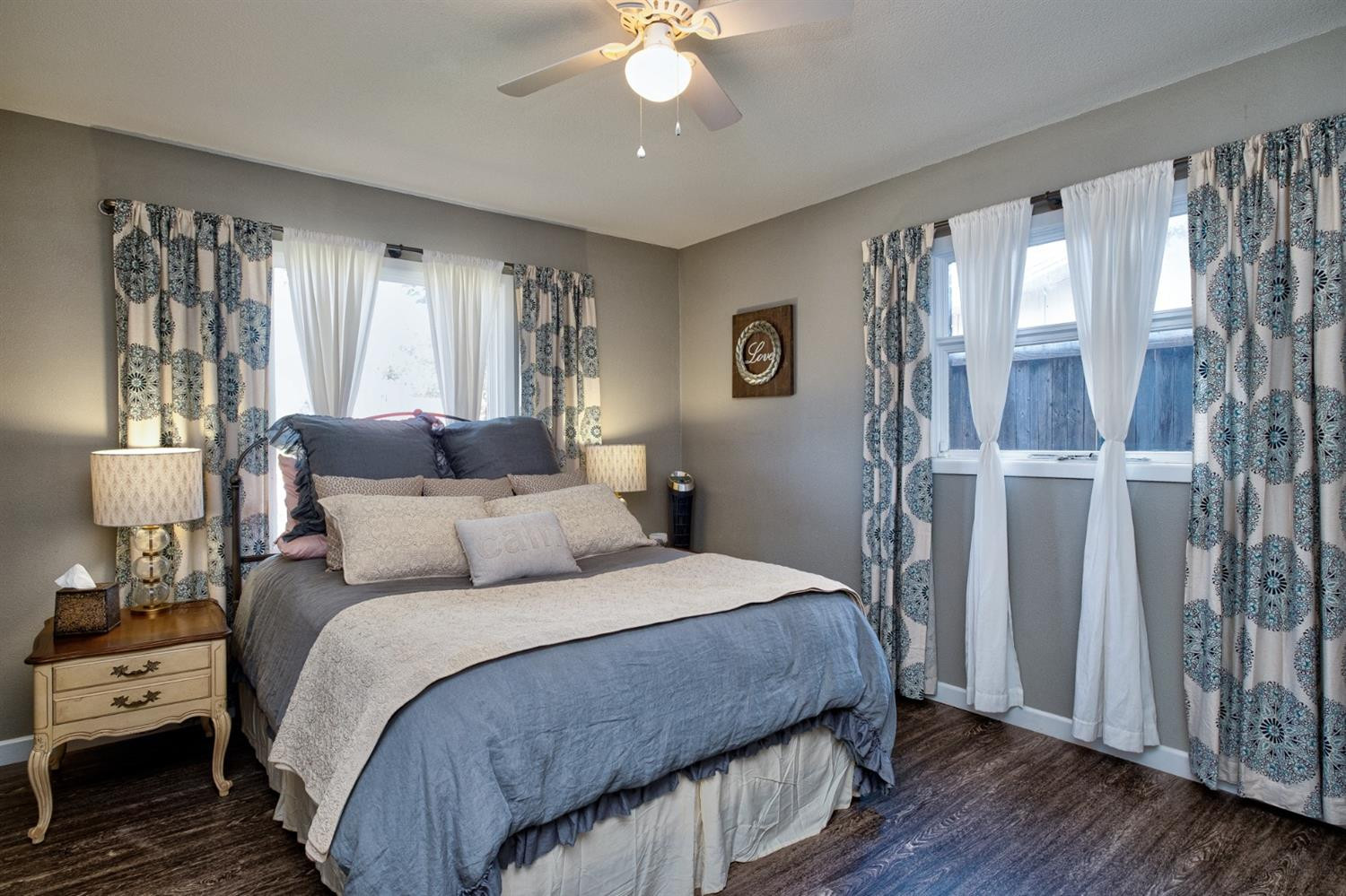 5209 16th Street Lubbock, TX 79416 - Photo 14 of 23 a bedroom with a large bed and a chandelier