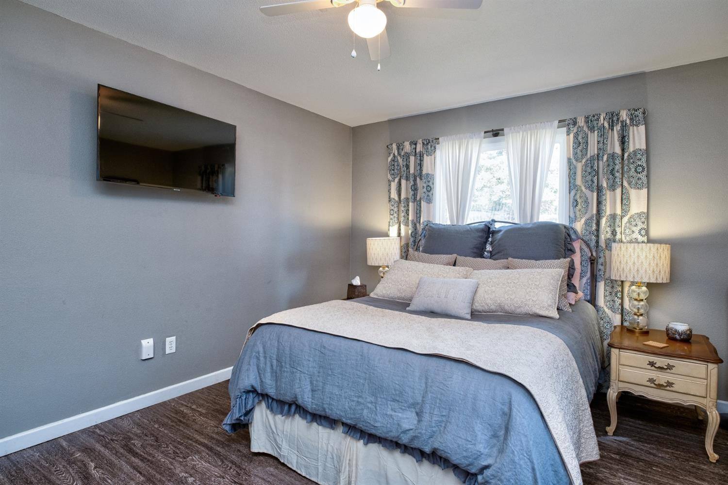 5209 16th Street Lubbock, TX 79416 - Photo 15 of 23 a bedroom with a bed and a flat screen tv