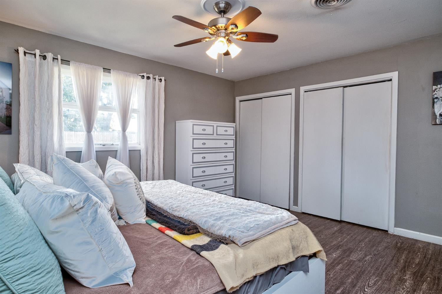 5209 16th Street Lubbock, TX 79416 - Photo 18 of 23 a bedroom with a bed and a chandelier