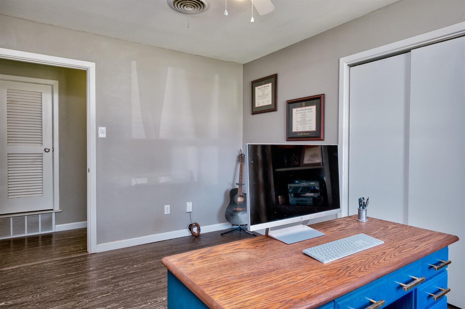 5209 16th Street Lubbock, TX 79416 - Photo 20 of 23 a bedroom with a bed and a fireplace