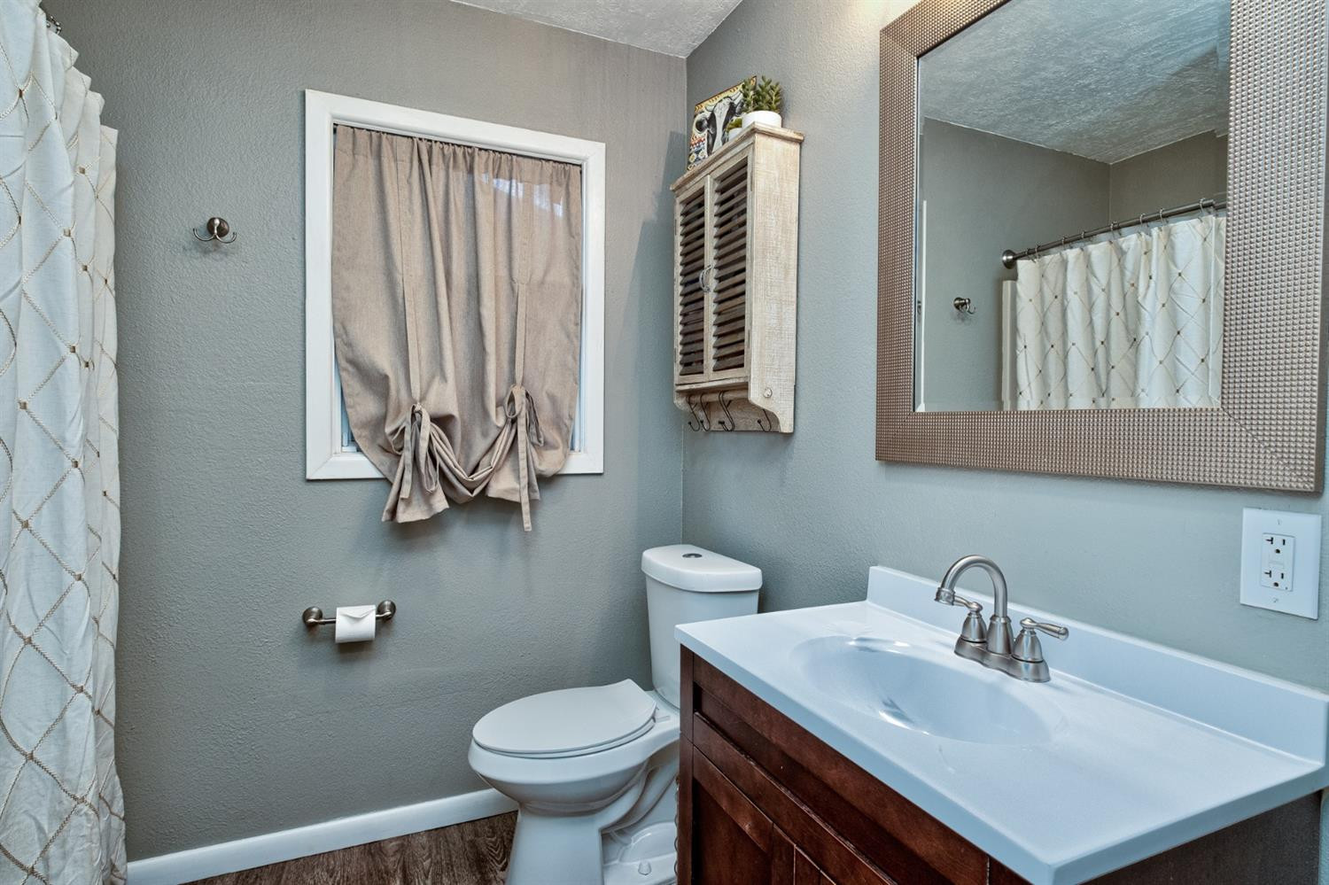 5209 16th Street Lubbock, TX 79416 - Photo 21 of 23 a bathroom with a sink toilet and mirror