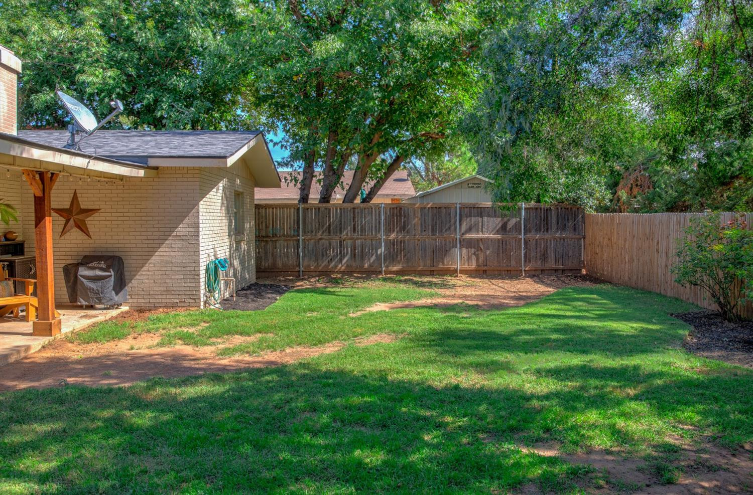 5209 16th Street Lubbock, TX 79416 - Photo 23 of 23 a view of a backyard with a small cabin