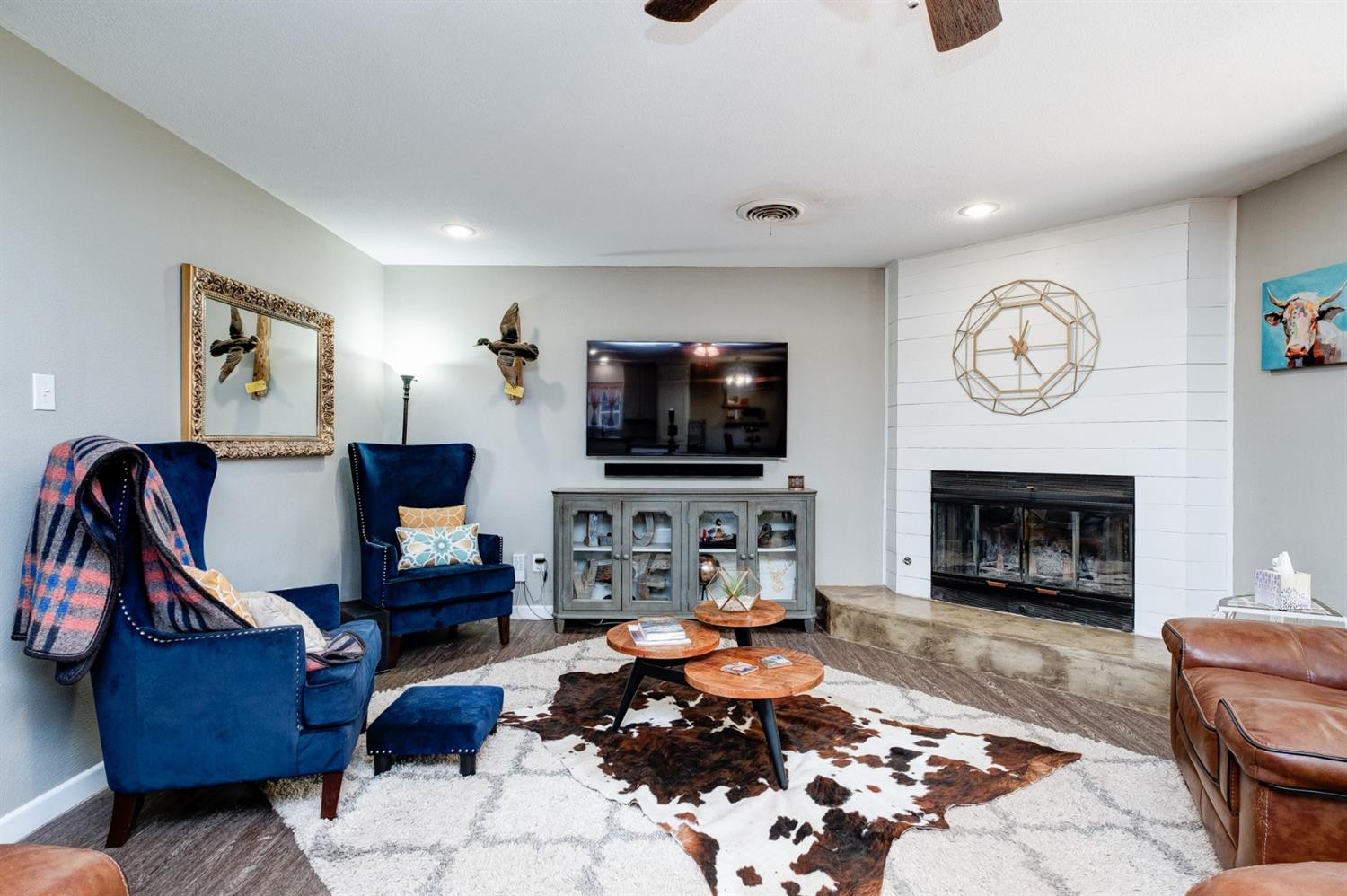 5209 16th Street Lubbock, TX 79416 - Photo 3 of 23 a living room with furniture a flat screen tv and a fireplace