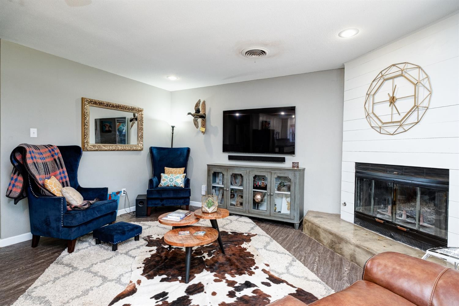 5209 16th Street Lubbock, TX 79416 - Photo 4 of 23 a living room with furniture a flat screen tv and a fireplace