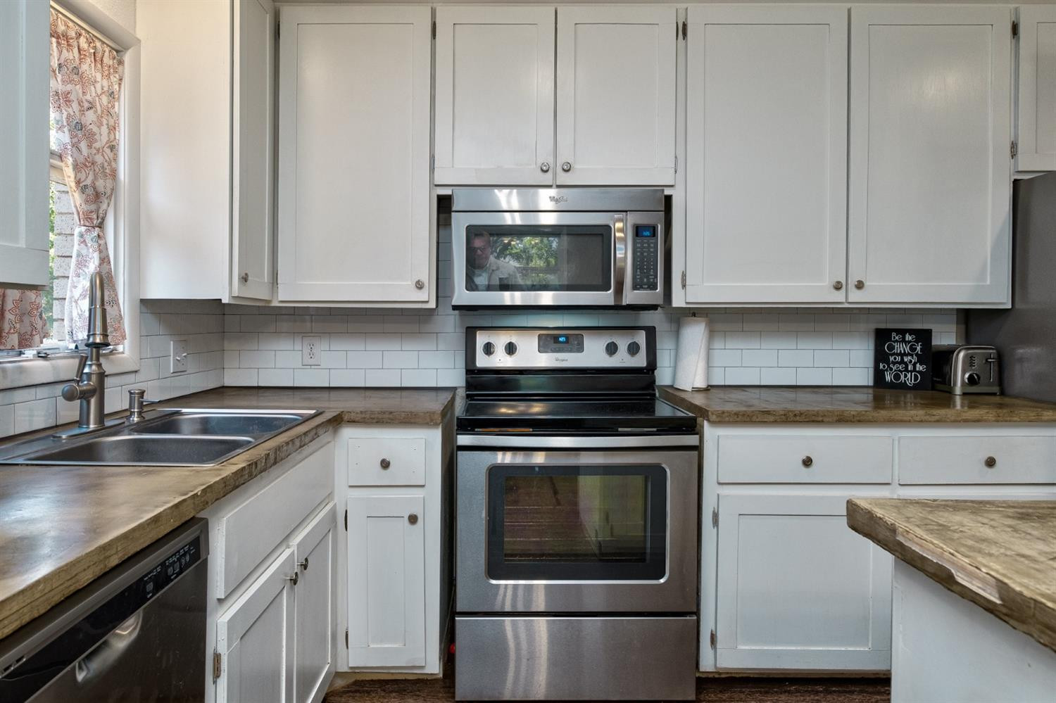 5209 16th Street Lubbock, TX 79416 - Photo 10 of 23 a kitchen with granite countertop white cabinets and a stove