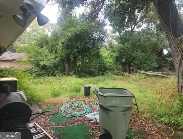 a view of a backyard with plants and a patio