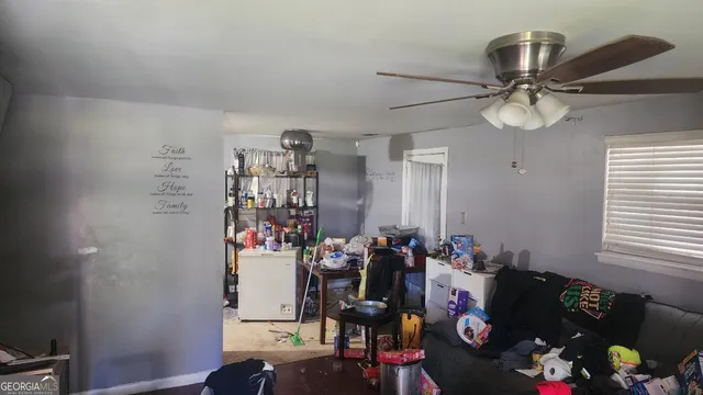 a room with gym equipment and wooden floor