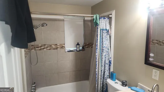 a bathroom with a bathtub and shower