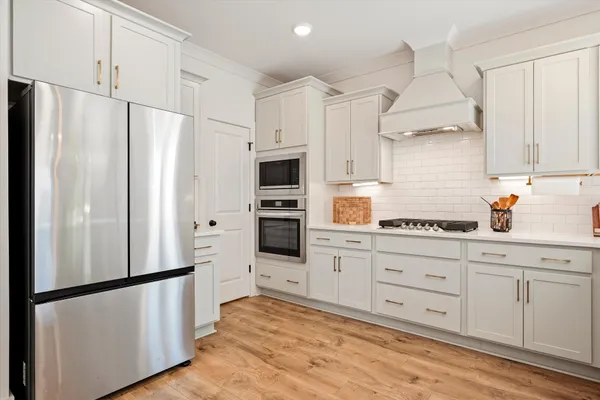 a kitchen with stainless steel appliances a refrigerator sink and cabinets