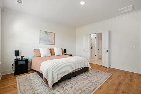 a bedroom with a bed and a night stand
