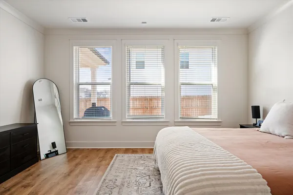a bedroom with a large bed and a large window
